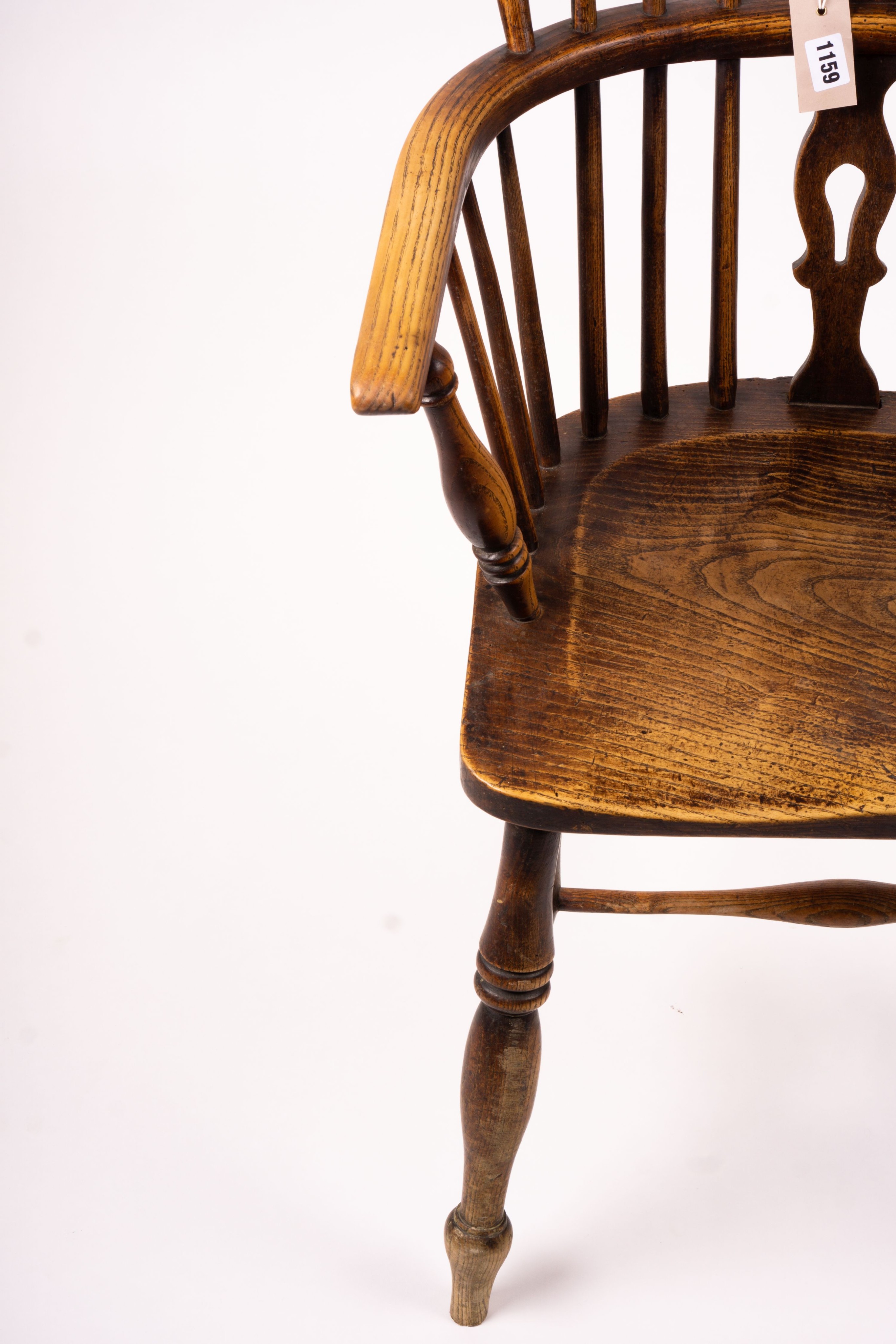 A mid 19th century ash and elm Derbyshire area Windsor elbow chair, together with a 19th century yew and elm Windsor wheel back chair with crinoline stretcher